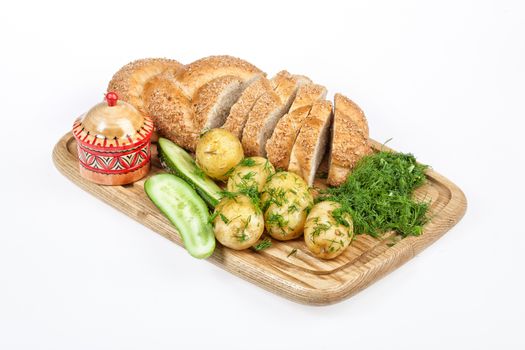 Potatoes, greenery and tableware on isolated satudio background