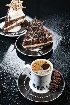 Cup of coffee and chocolate cake on a glass background