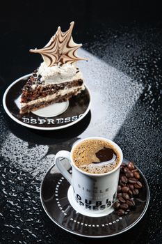 Cup of coffee and chocolate cake on a glass background