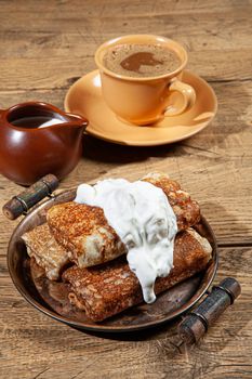 Pancakes and cream on a canvas studio background