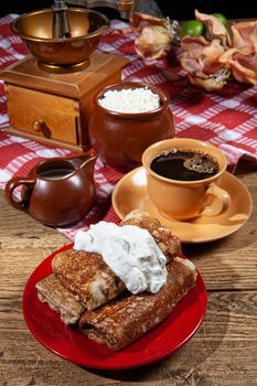 Pancakes and cream on a canvas studio background