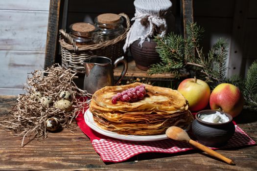 Plate with pancakes on an old wooden background
