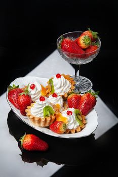 Still life with strawberries on a studio background