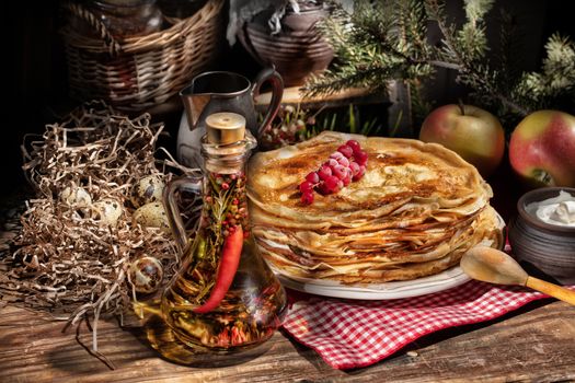 Plate with pancakes on an old wooden background