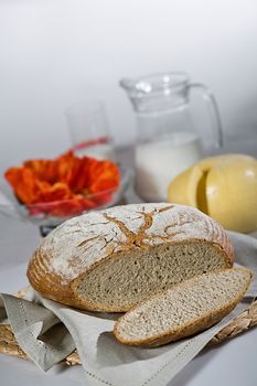 Pieces of bread, glass of milk and poppy