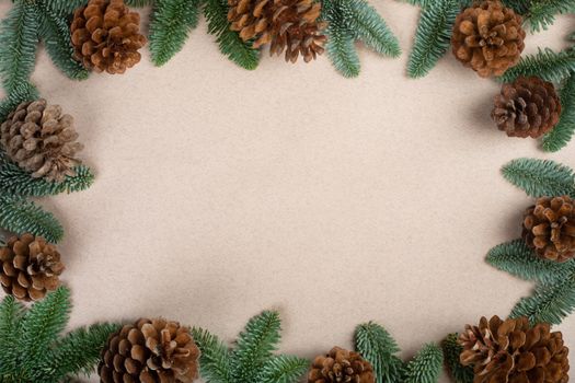 Traditional green christmas tree noble fir and cones border frame on craft paper background copy space for text