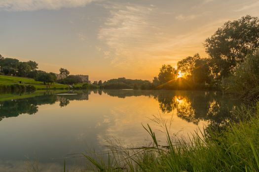 Sunset view of the lake, with the Antipatris Fort (Binar Bashi), in Yarkon (Tel Afek) National Park, central Israel