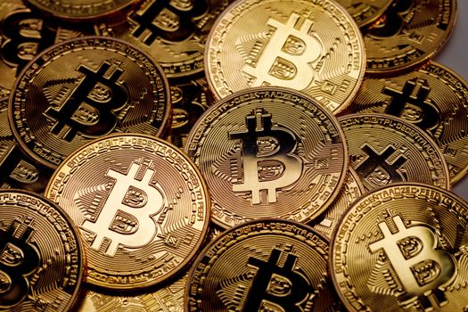 Background of gold coins with bitcoin sign