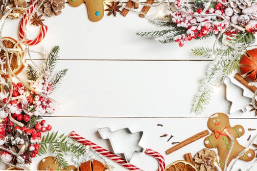 Christmas food frame. Gingerbread cookies, spices and decorations on white table background with copy space