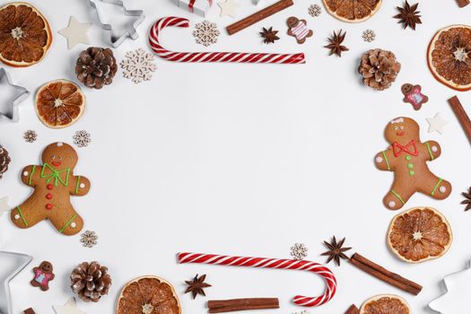 Christmas food frame. Gingerbread cookies, spices and decorations on white background with copy space