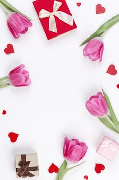 Pink tulip flowers gifts red hearts and gifts composition isolated on white background top view with copy space. Valentine's day, birthday, wedding, Mother's day concept. Copy space
