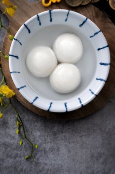 Top view of big tangyuan yuanxiao (glutinous rice dumpling balls) for lunar new year festival food, words on the golden coin means the Dynasty name it made.