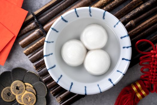 Top view of big tangyuan yuanxiao (glutinous rice dumpling balls) for lunar new year festival food, words on the golden coin means the Dynasty name it made.