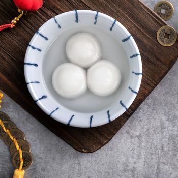 Top view of big tangyuan yuanxiao (glutinous rice dumpling balls) for lunar new year festival food, words on the golden coin means the Dynasty name it made.
