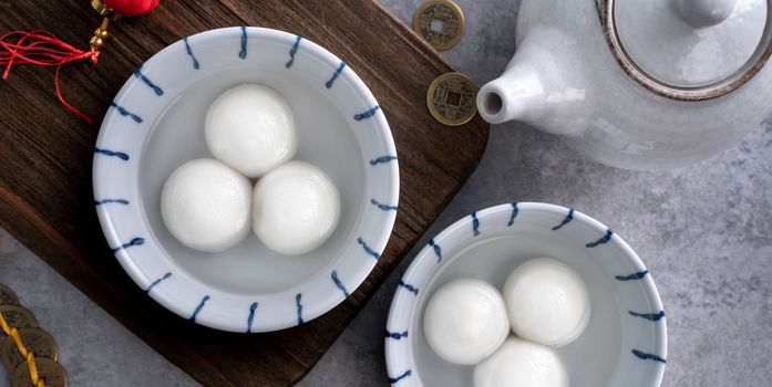 Top view of big tangyuan yuanxiao (glutinous rice dumpling balls) for lunar new year festival food, words on the golden coin means the Dynasty name it made.
