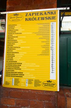 Menu of zapiekanka pies at a popular Polish street food store.