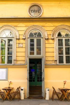 A street bad square at the entrance to a vintage cafe in the city of old Europe.