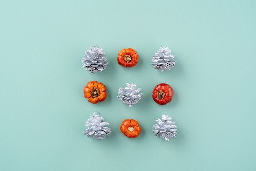 Top view of Christmas holiday decoration ornament composition with Christmas tree, gift star, gingerbread man flat lay with copy space isolated on green background.