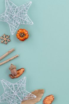 Top view of Christmas holiday decoration ornament composition with Christmas tree, gift star, gingerbread man flat lay with copy space isolated on green background.