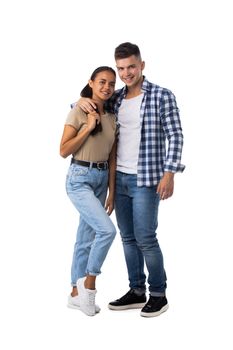 Smiling young couple embracing and standing full length isolated on white background