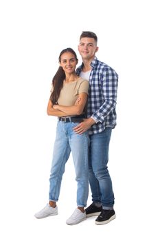 Smiling young couple embracing and standing full length isolated on white background