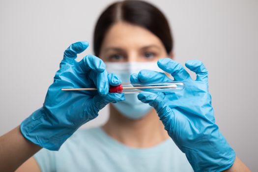 Medical healthcare nurse holding Coronavirus COVID-19 swab test kit, PPE protective mask and gloves, tube for taking OP NP patient specimen sample, PCR DNA RNA testing protocol process stock photo