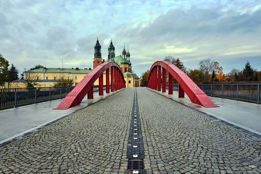 The steel structure of the bridge and the towers of the Gothic Catholic cathedral in Poznan