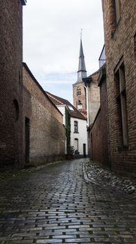 Narrow road in the city of Bruges - buildings and architecture of Bruges
