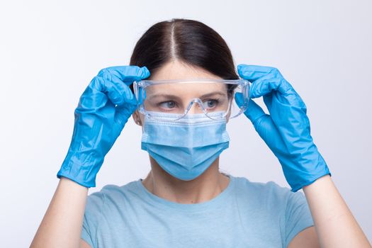 Nurse or doctor wearing and checking protective equipment against viruses and bacterial disease stock photo