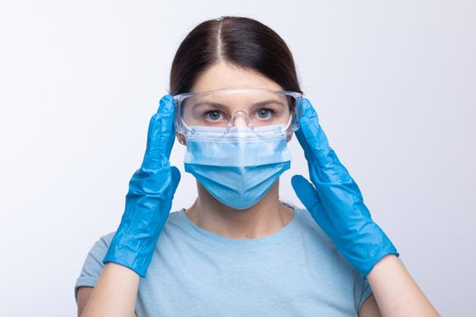 Nurse or doctor wearing and checking protective equipment against viruses and bacterial disease stock photo