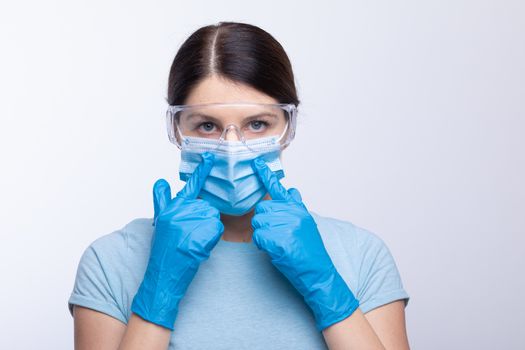 Nurse or doctor wearing and checking protective equipment against viruses and bacterial disease stock photo