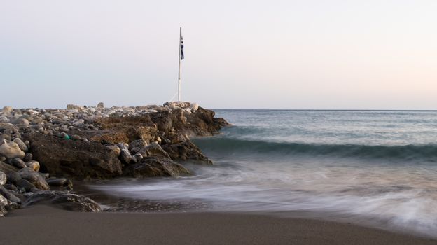 Sea shore in Keratokampos, Crete with a pier of stones and clear sky