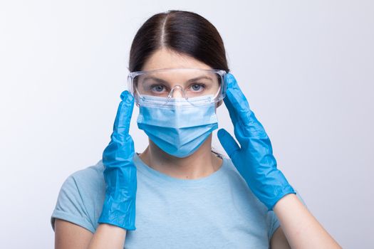 Nurse or doctor wearing and checking protective equipment against viruses and bacterial disease stock photo