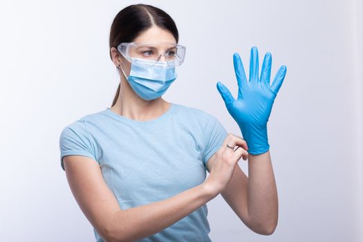 Nurse or doctor wearing and checking protective equipment against viruses and bacterial disease stock photo