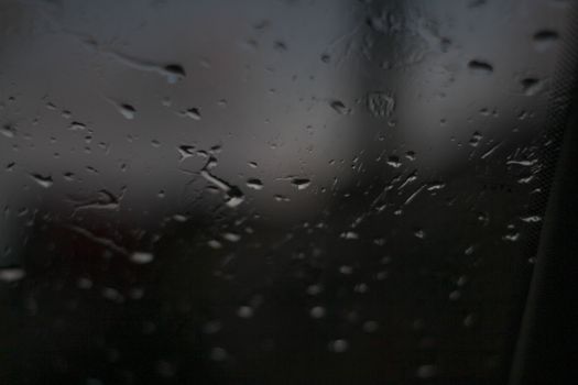 Rain drops on the window in the dark - water on the window