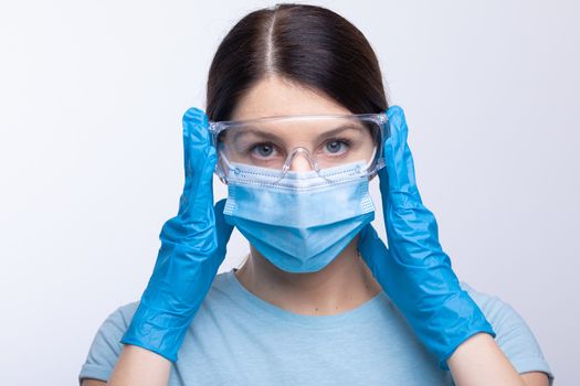 Nurse or doctor wearing and checking protective equipment against viruses and bacterial disease stock photo