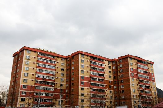 Apartment buildings with similar colors and clouds on the sky