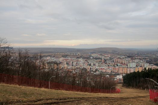 Landscape of city with apartment buildings seen from the hill