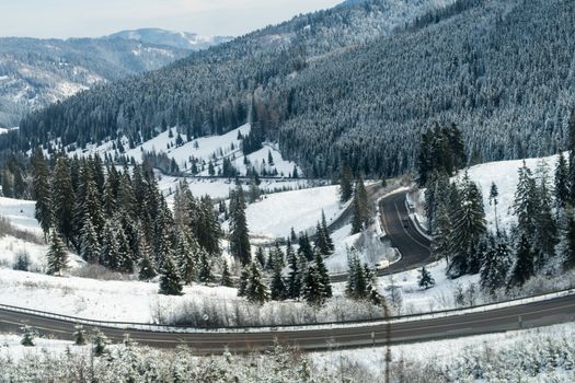 Bending roads in the moutains after heavy snow during winter in Romania