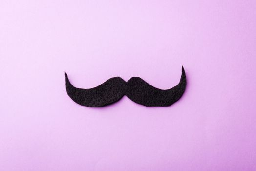 Black mustache paper, studio shot isolated on purple background, Prostate cancer awareness month, Fathers day, minimal November moustache concept