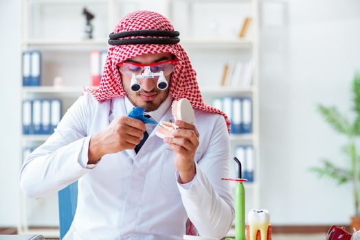 Arab dentist working on new teeth implant