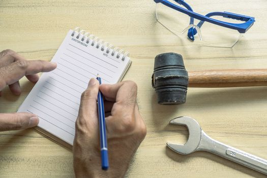 Hand people man with notepad For checking factory or industry on desk for note writing inspector.Metaphor Quality inspection or Production speed For the best quality to customers.