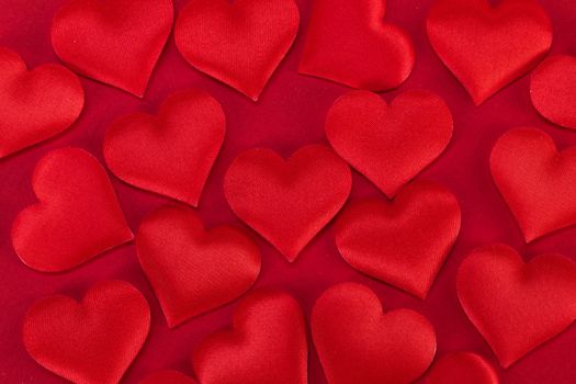 Valentine's day many red silk hearts background, love concept