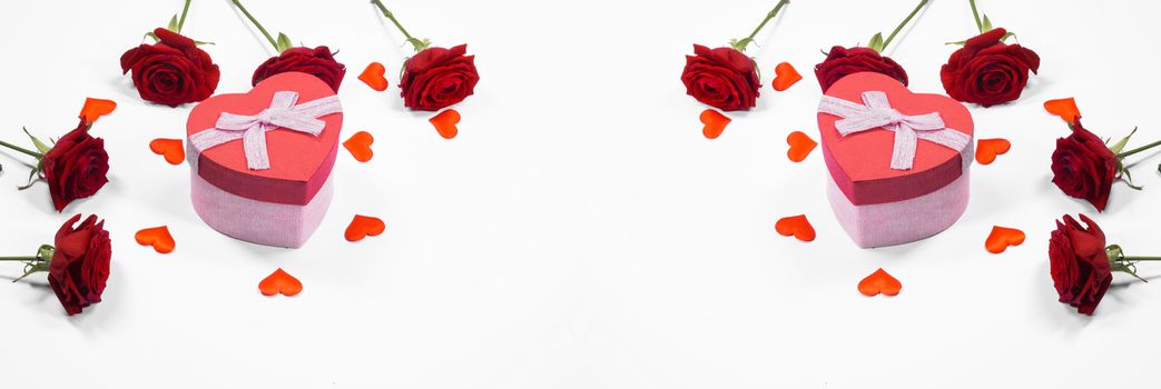 Beautiful gift in heart shaped box with ribbon bow rose flowers and paper hearts isolated on white background