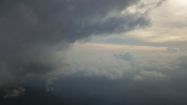 Rays of light shining through dark clouds for background.