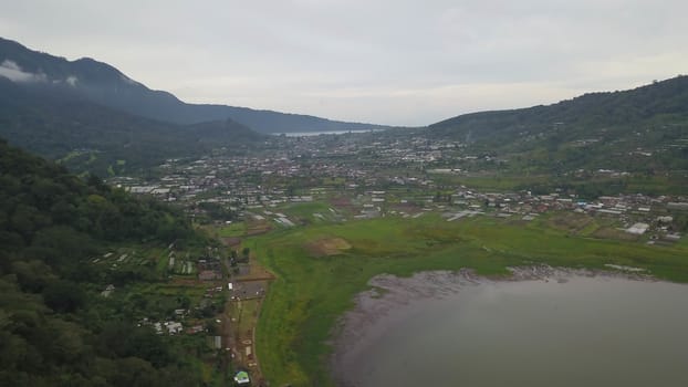 Beatiful aerial drone view over the lake. Lake and mountain view from a hill, Buyan Lake, Bali.