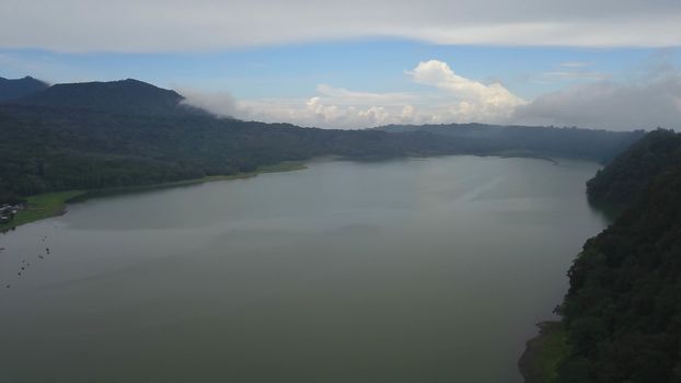 Beatiful aerial drone view over the lake. Lake and mountain view from a hill, Buyan Lake, Bali.