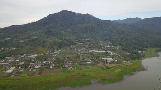 Beatiful aerial drone view over the lake. Lake and mountain view from a hill, Buyan Lake, Bali.