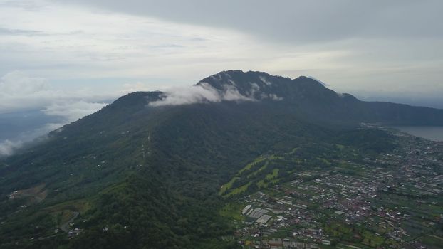 Green Bali landscape. Aerial drone view to Buyan lake and Bedugul village. Indonesia.