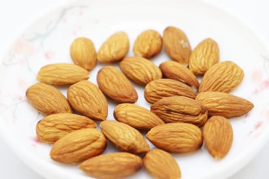 tasty and healthy brown colored almond stock on white background
